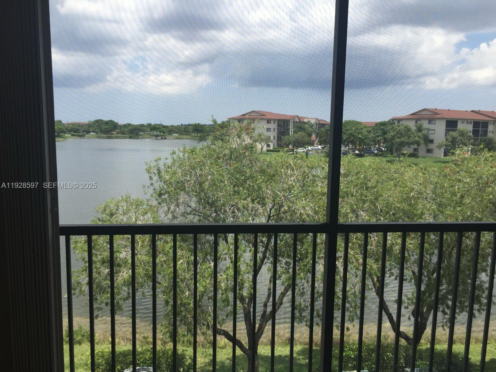 1201 Southwest 141st Avenue, Unit 304J Pembroke Pines, FL 33027 - Photo 3 of 31 a view of a balcony with lake from a balcony