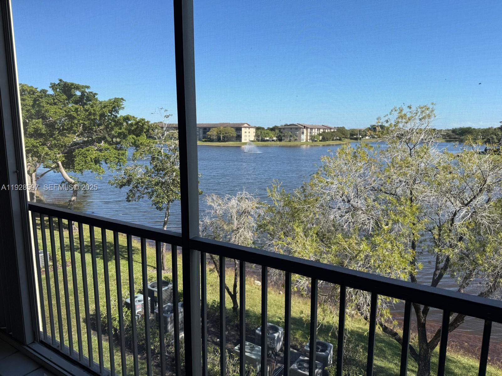 1201 Southwest 141st Avenue, Unit 304J Pembroke Pines, FL 33027 - Photo 4 of 31 a view of a balcony with wooden floor and city view