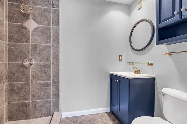 a bathroom with a sink toilet and a mirror