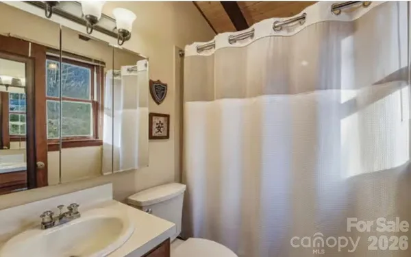 a bedroom with a bed couch and a window