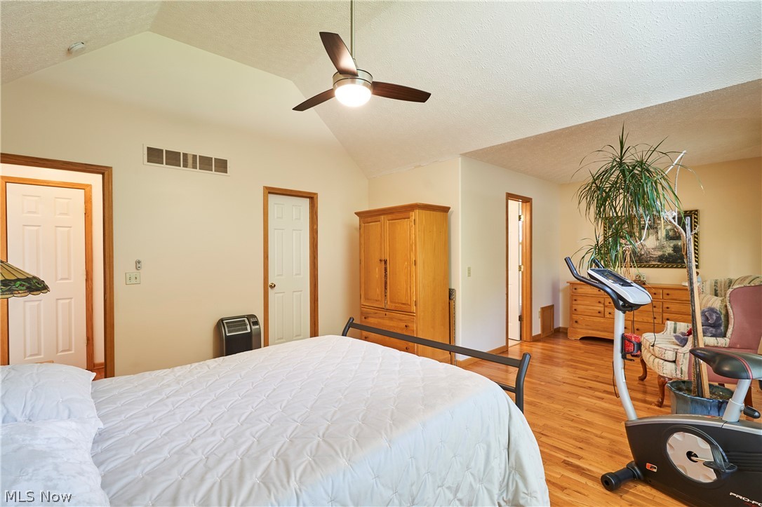 1963 Haines Road Madison, OH 44057 - Photo 10 of 34 Spacious room featuring wood-finish flooring, a vaulted ceiling, and a ceiling fan