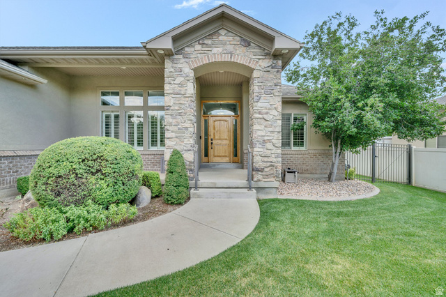 319 River Rock Road Spanish Fork, UT 84660 - Photo 1 of 1 Inviting stone entry with a natural wood front door and covered front porch.