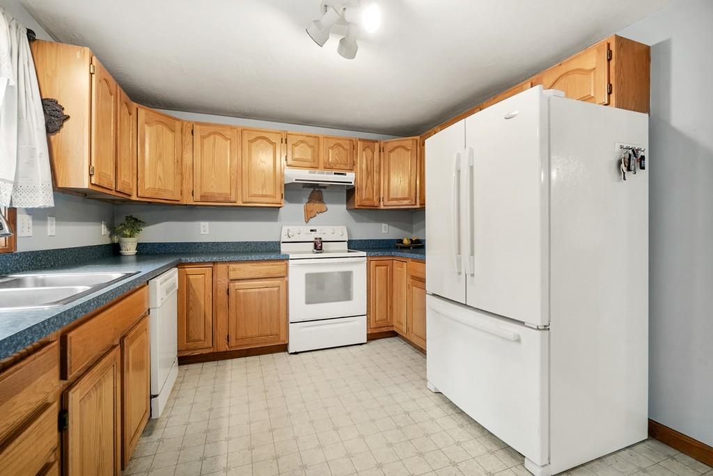 150 Lower Gore Road Webster, MA 01570 - Photo 6 of 20 a kitchen with white cabinets and white appliances