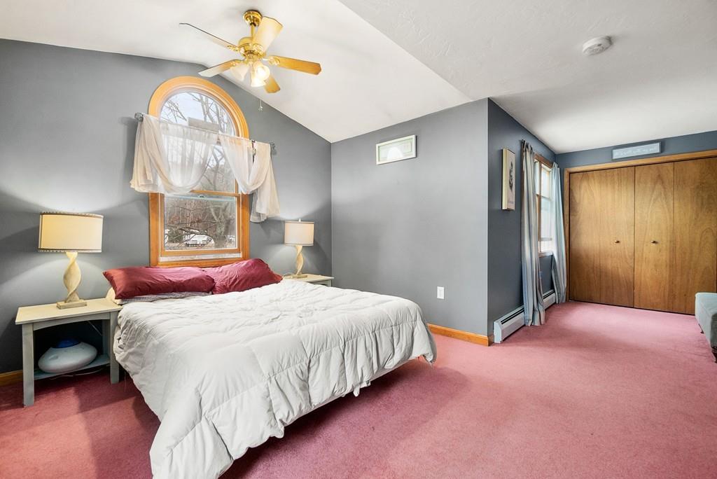 150 Lower Gore Road Webster, MA 01570 - Photo 10 of 20 a bedroom with a bed and a chandelier