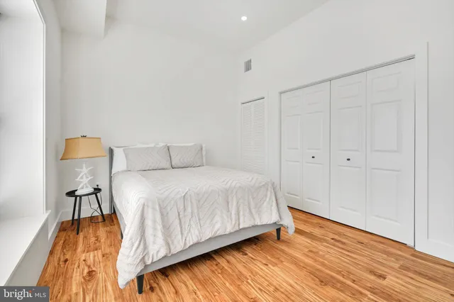 a bedroom with a bed and a table