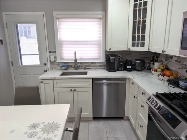 a kitchen that has a stove a table and chairs