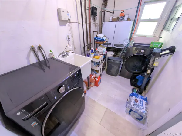 a view of a patio with table and chairs and floor to ceiling window