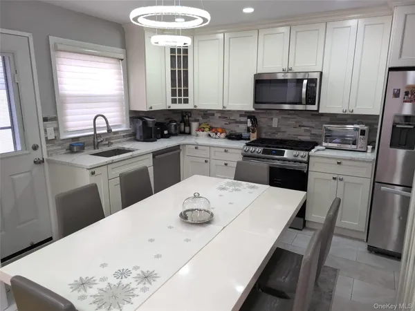 a view of a living room with furniture and a floor to ceiling window