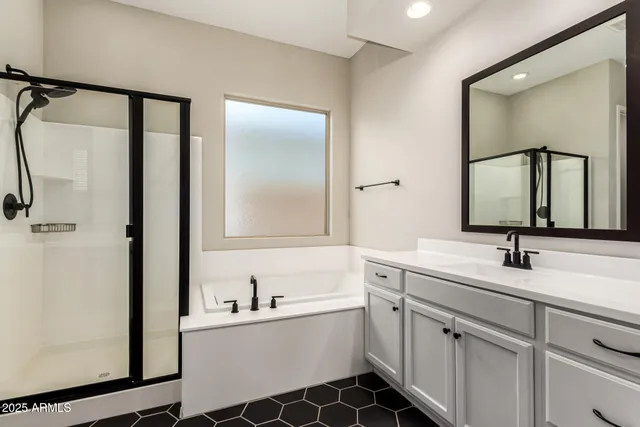 a bathroom with a double vanity sink mirror and