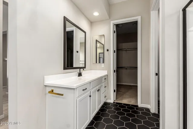 a bathroom with a double vanity sink and a mirror