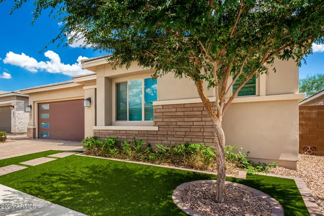 a front view of a house with a garden