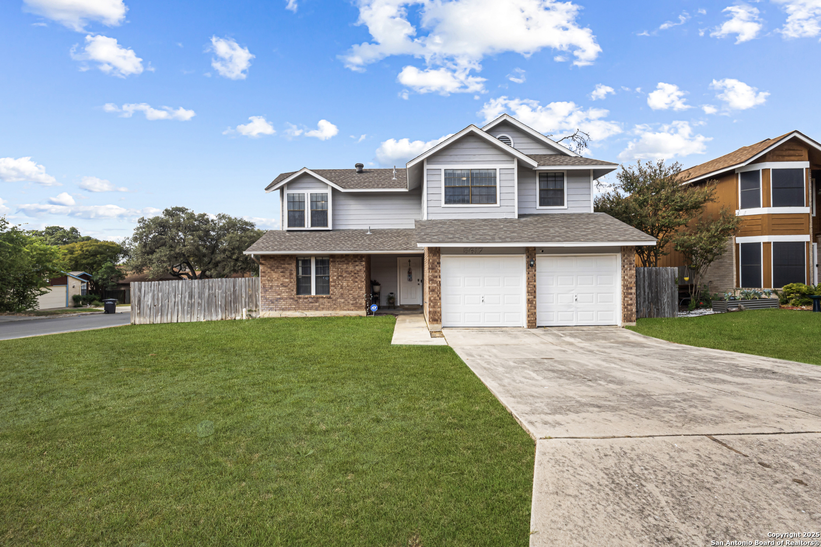 5617 Timber Rain San Antonio, TX 78250 - Photo 1 of 32 a front view of a house with a garden