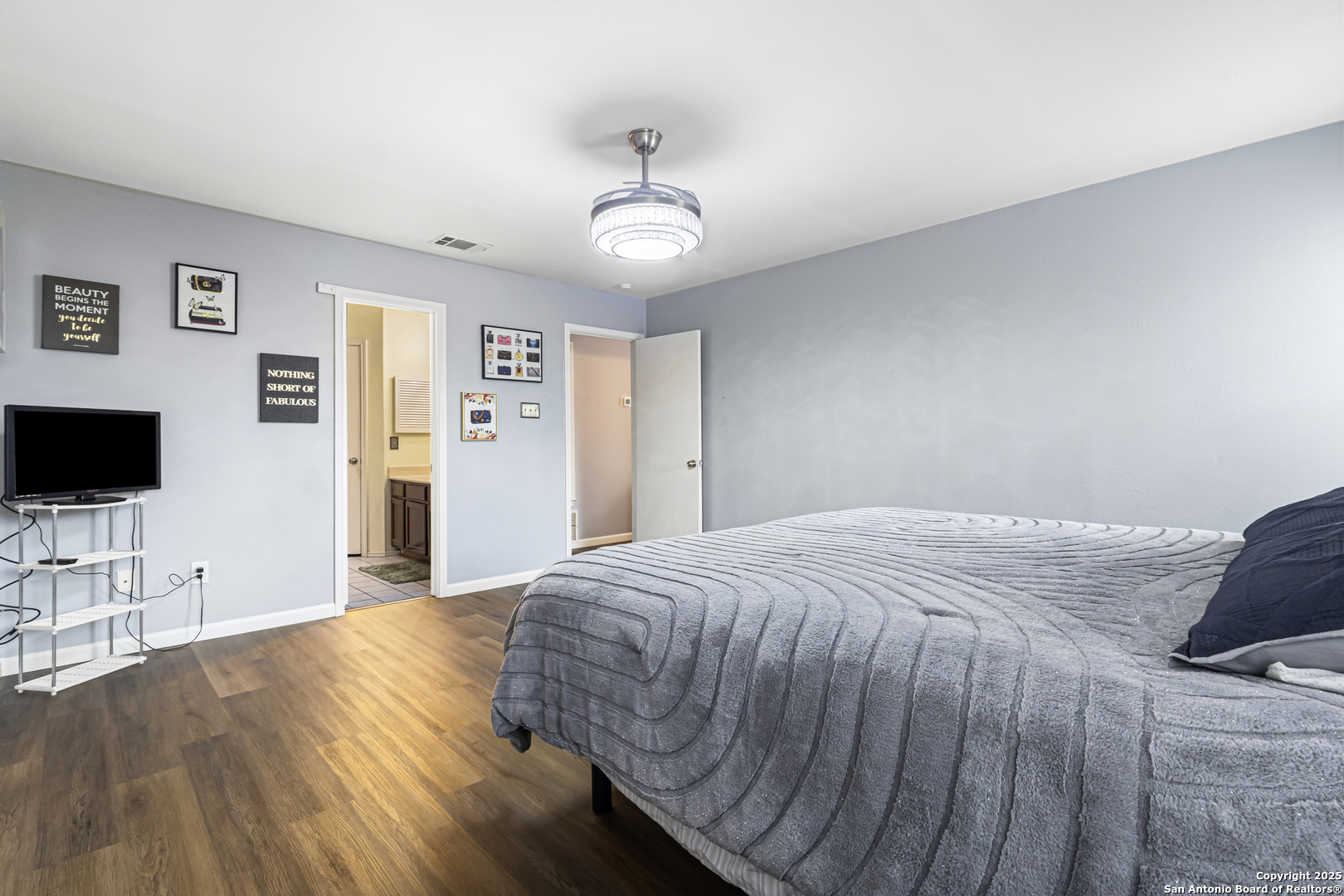 5617 Timber Rain San Antonio, TX 78250 - Photo 17 of 32 a bedroom with a bed and a flat screen tv