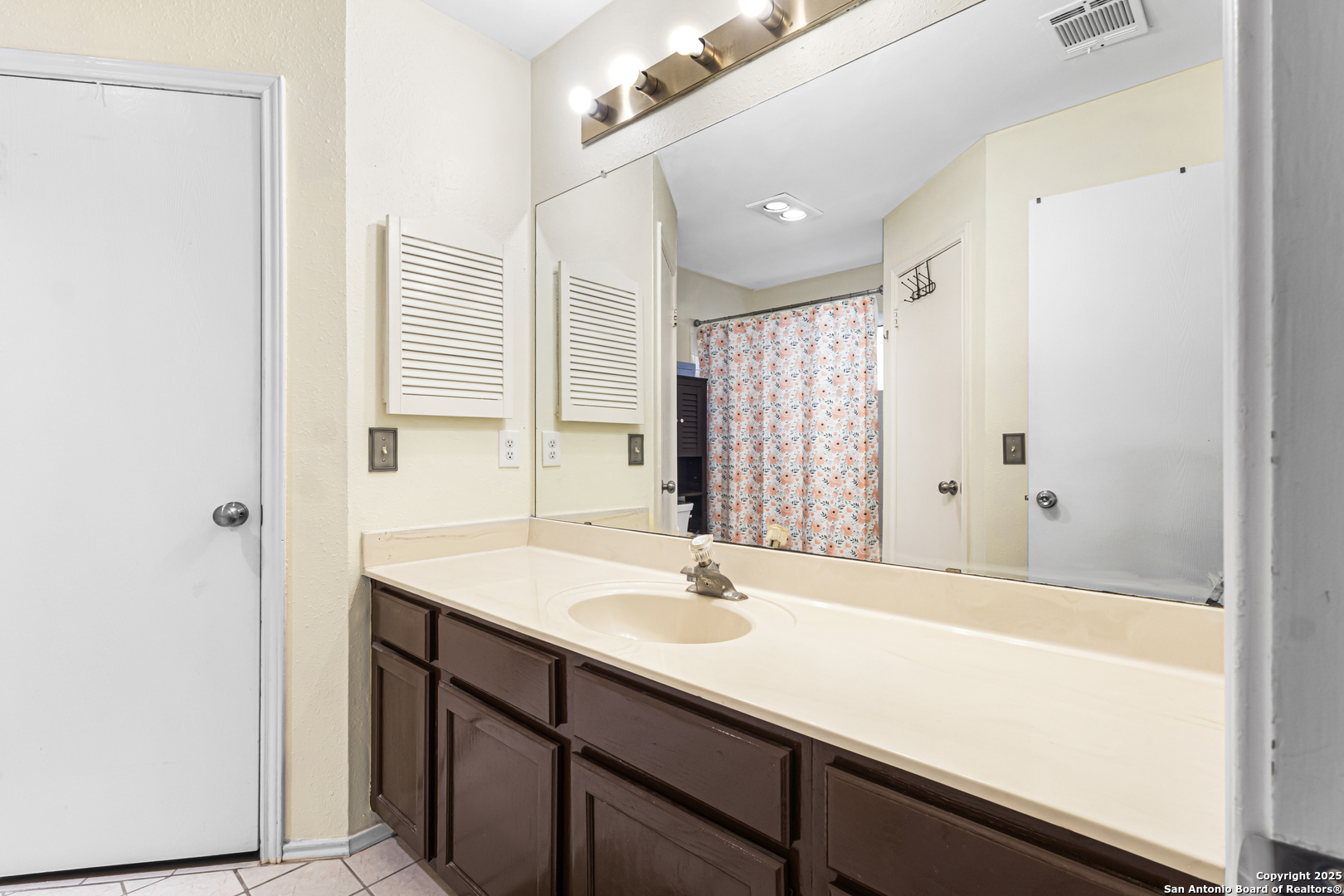 5617 Timber Rain San Antonio, TX 78250 - Photo 19 of 32 a bathroom with a sink and a mirror