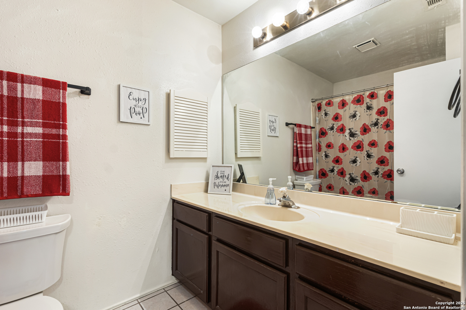 5617 Timber Rain San Antonio, TX 78250 - Photo 23 of 32 a bathroom with a sink a toilet and shower curtain