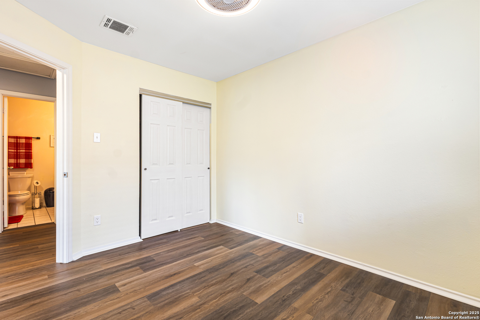 5617 Timber Rain San Antonio, TX 78250 - Photo 25 of 32 a view of an empty room with wooden floor and a window