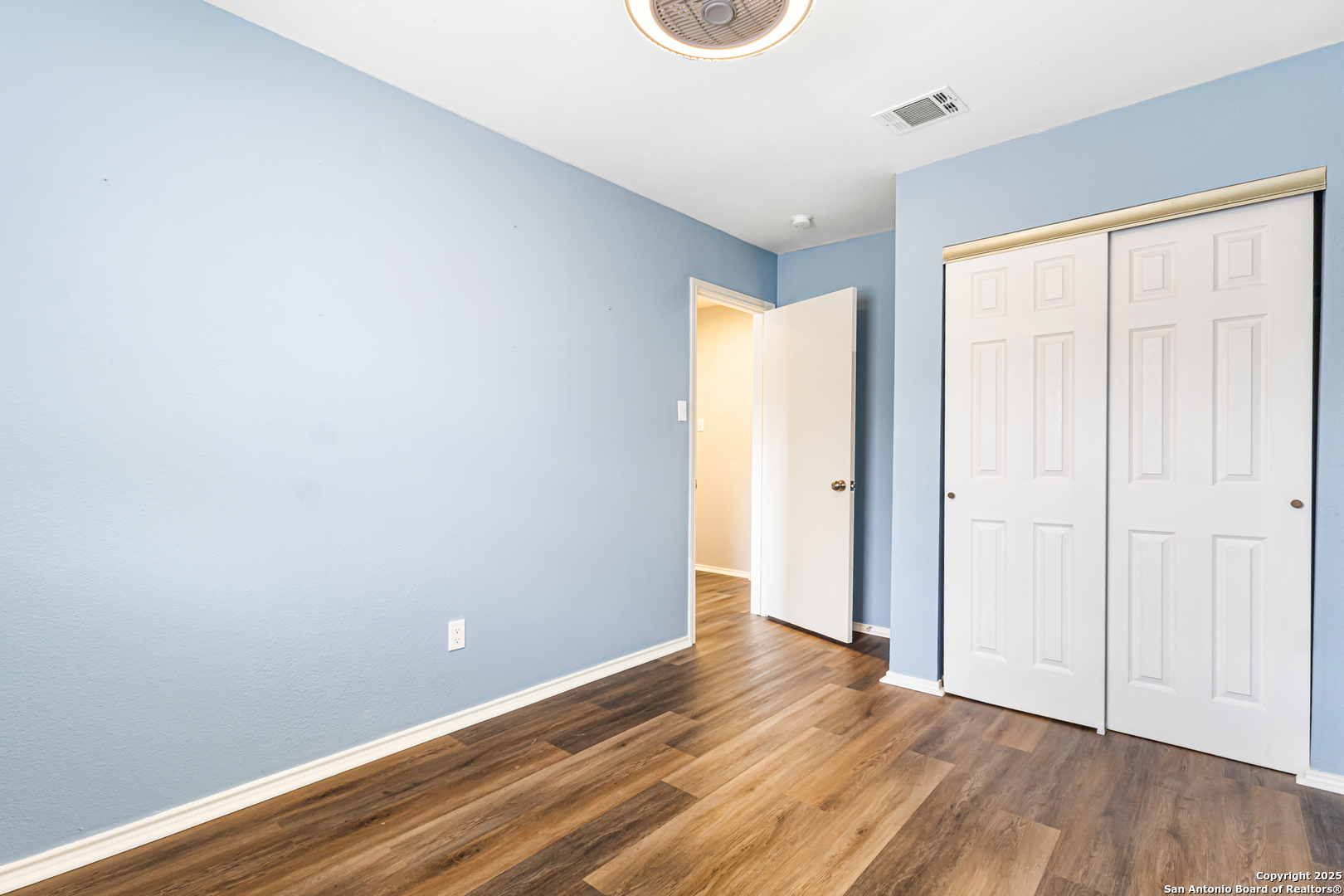 5617 Timber Rain San Antonio, TX 78250 - Photo 27 of 32 a view of an empty room with wooden floor and a window