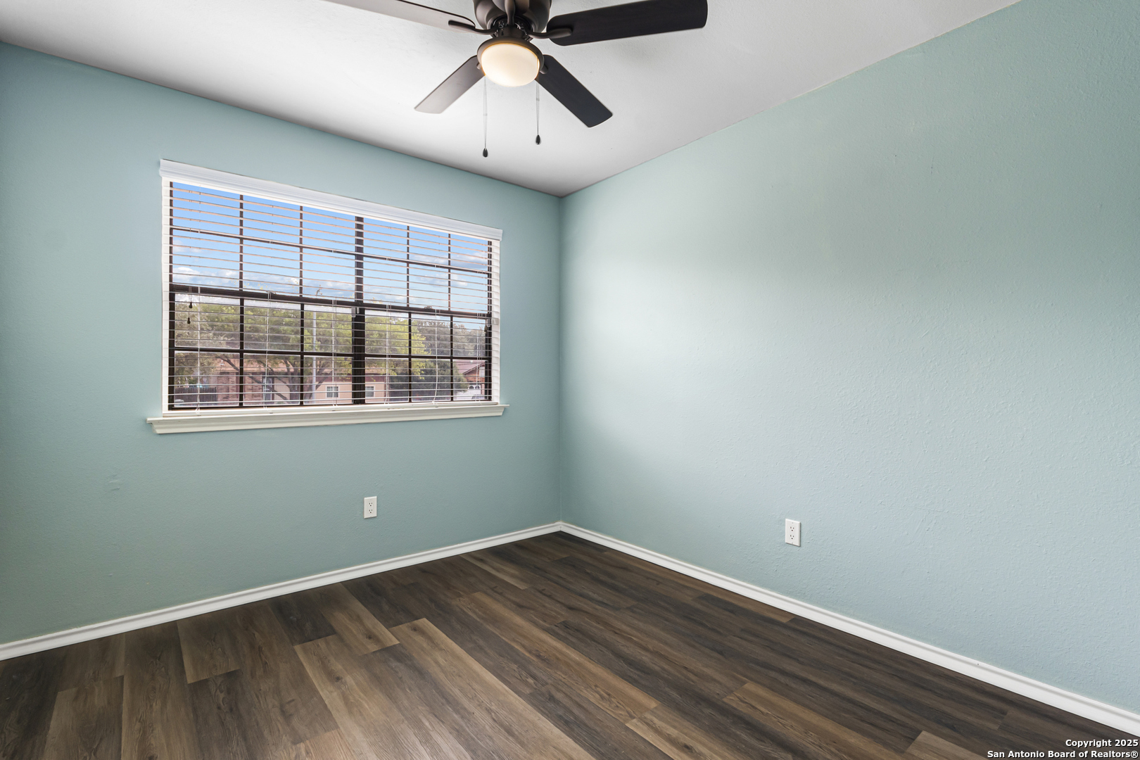 5617 Timber Rain San Antonio, TX 78250 - Photo 28 of 32 an empty room with wooden floor and windows