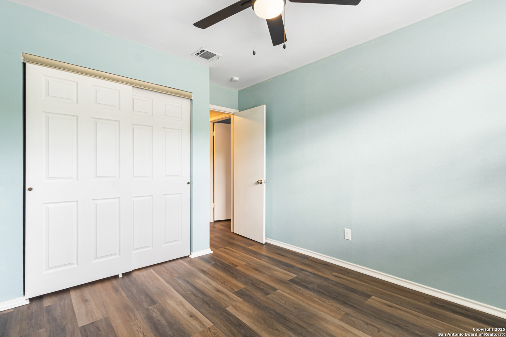 5617 Timber Rain San Antonio, TX 78250 - Photo 29 of 32 an empty room with wooden floor cabinet and ceiling fan
