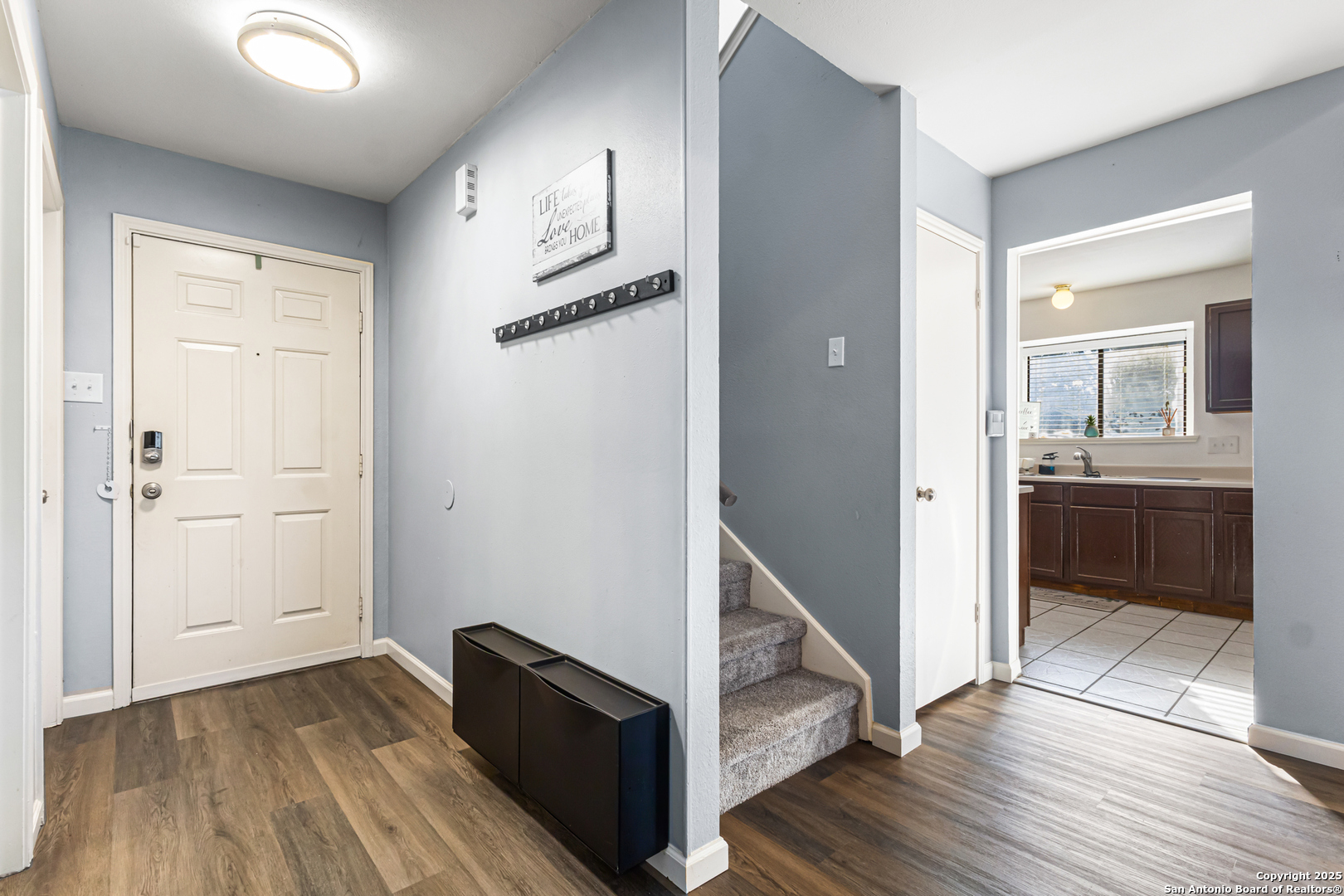 5617 Timber Rain San Antonio, TX 78250 - Photo 3 of 32 a view of a hallway with wooden floor and a living room
