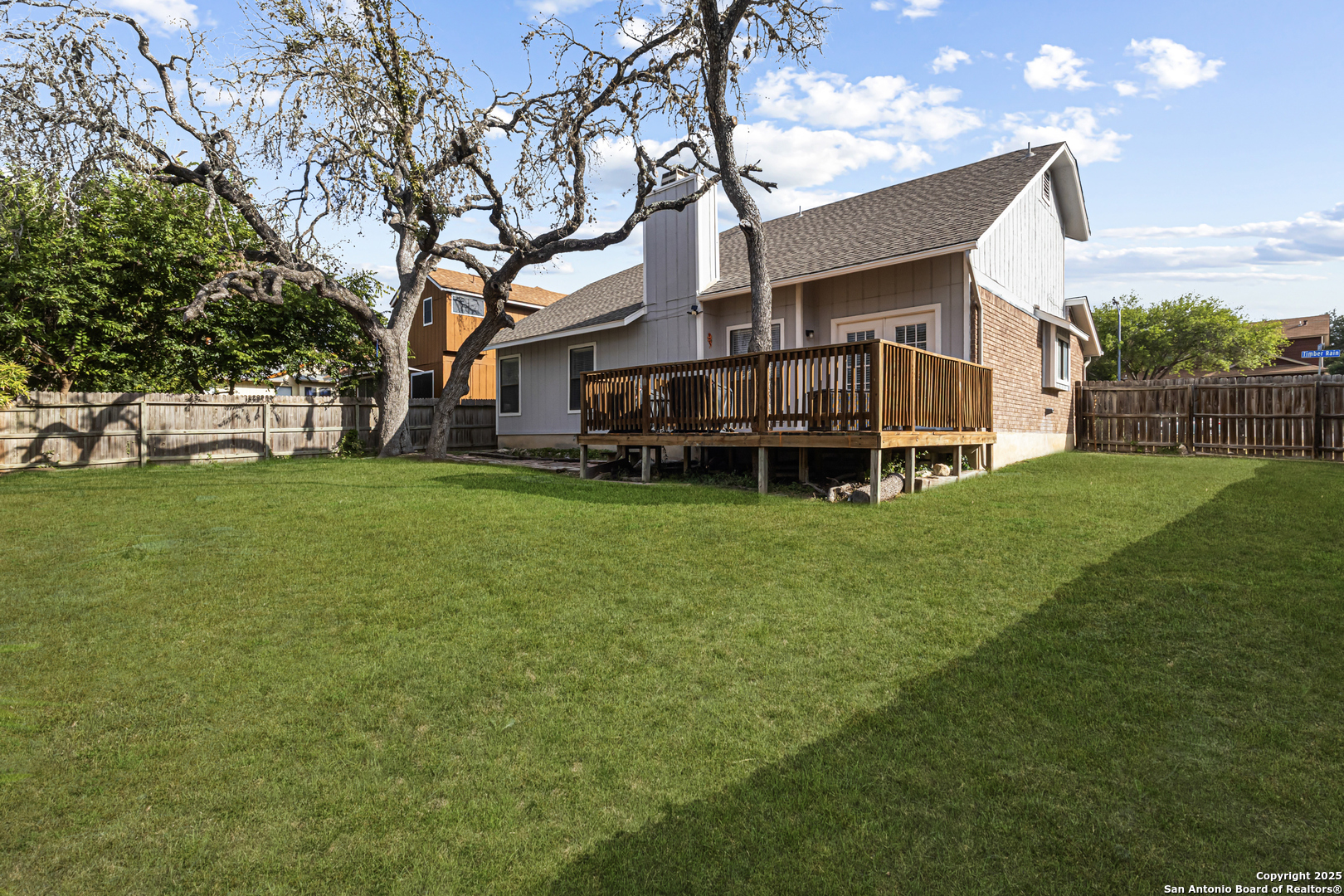 5617 Timber Rain San Antonio, TX 78250 - Photo 31 of 32 a view of a house with a big yard and large trees