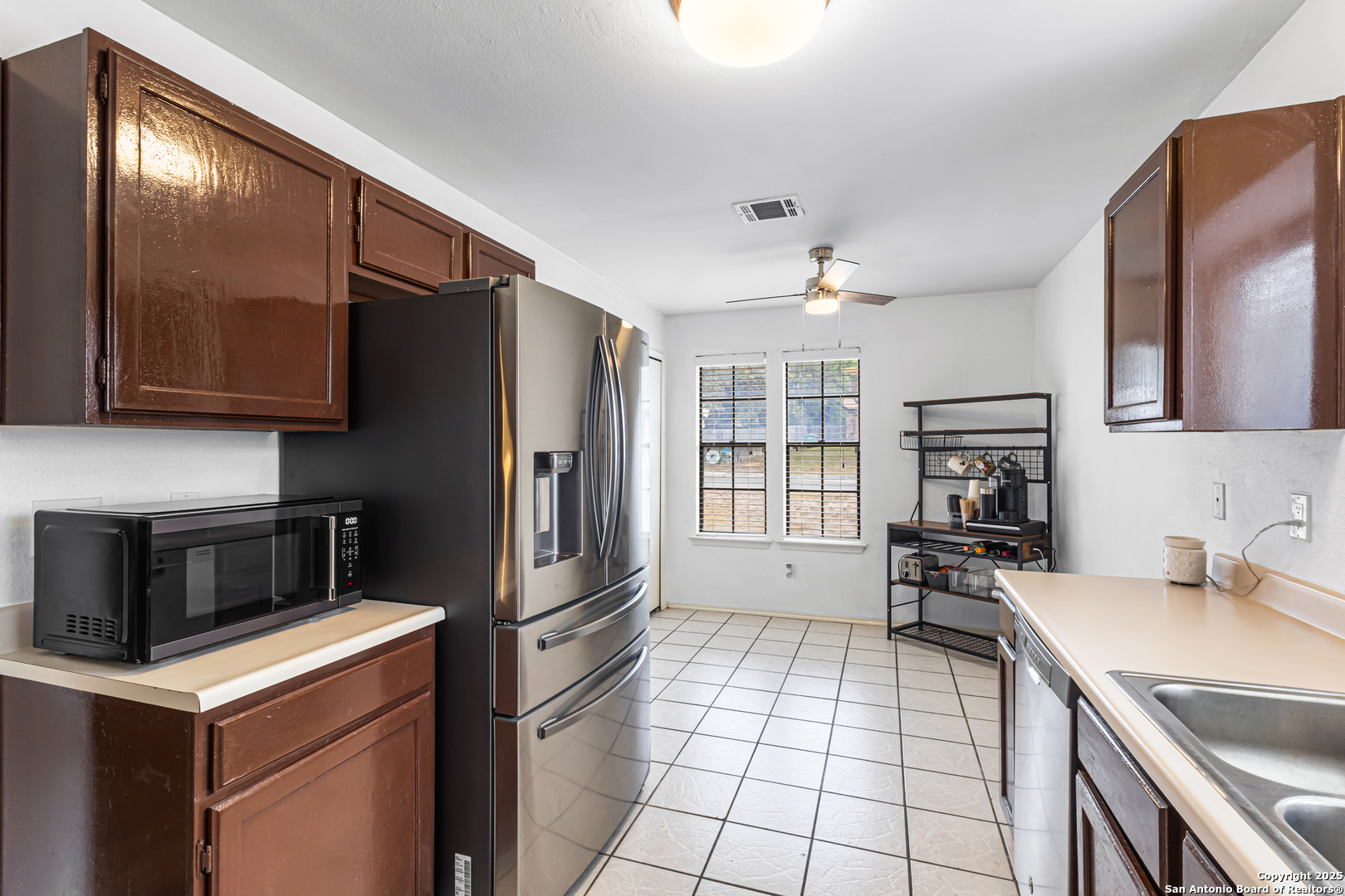 5617 Timber Rain San Antonio, TX 78250 - Photo 5 of 32 a kitchen that has a sink and a stove top oven