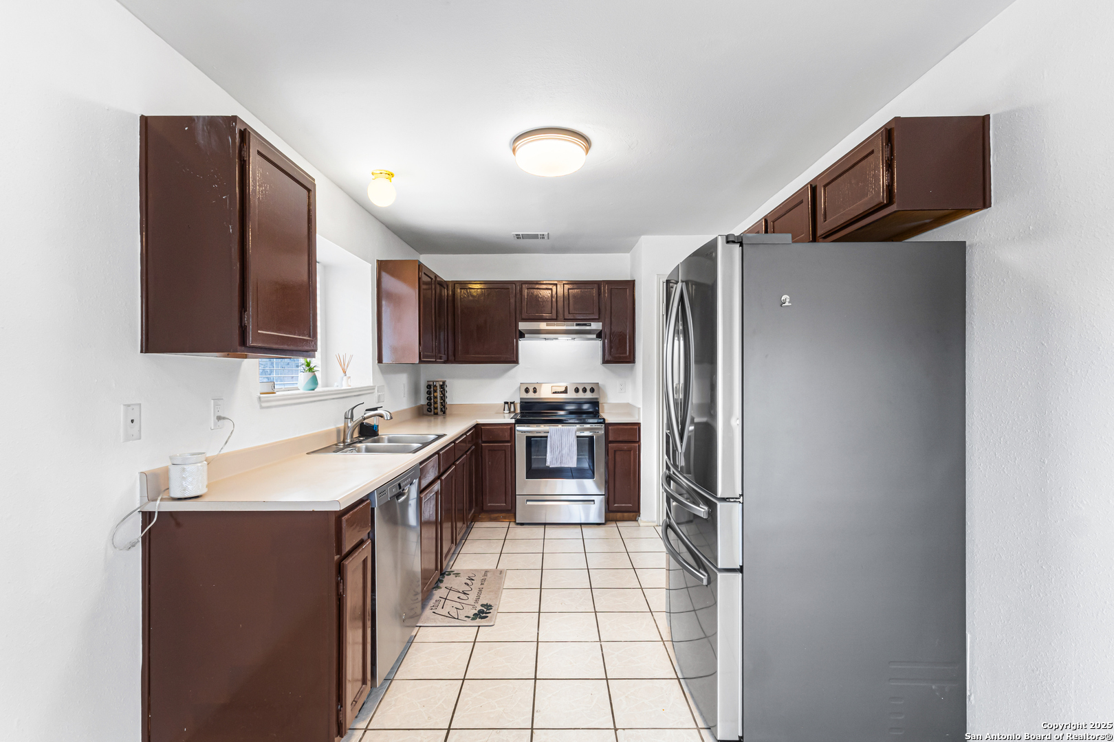 5617 Timber Rain San Antonio, TX 78250 - Photo 6 of 32 a kitchen with stainless steel appliances granite countertop a refrigerator stove and sink