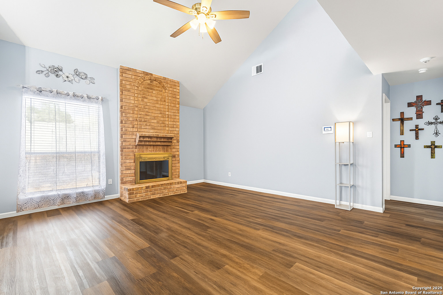 5617 Timber Rain San Antonio, TX 78250 - Photo 10 of 32 an empty room with wooden floor and windows