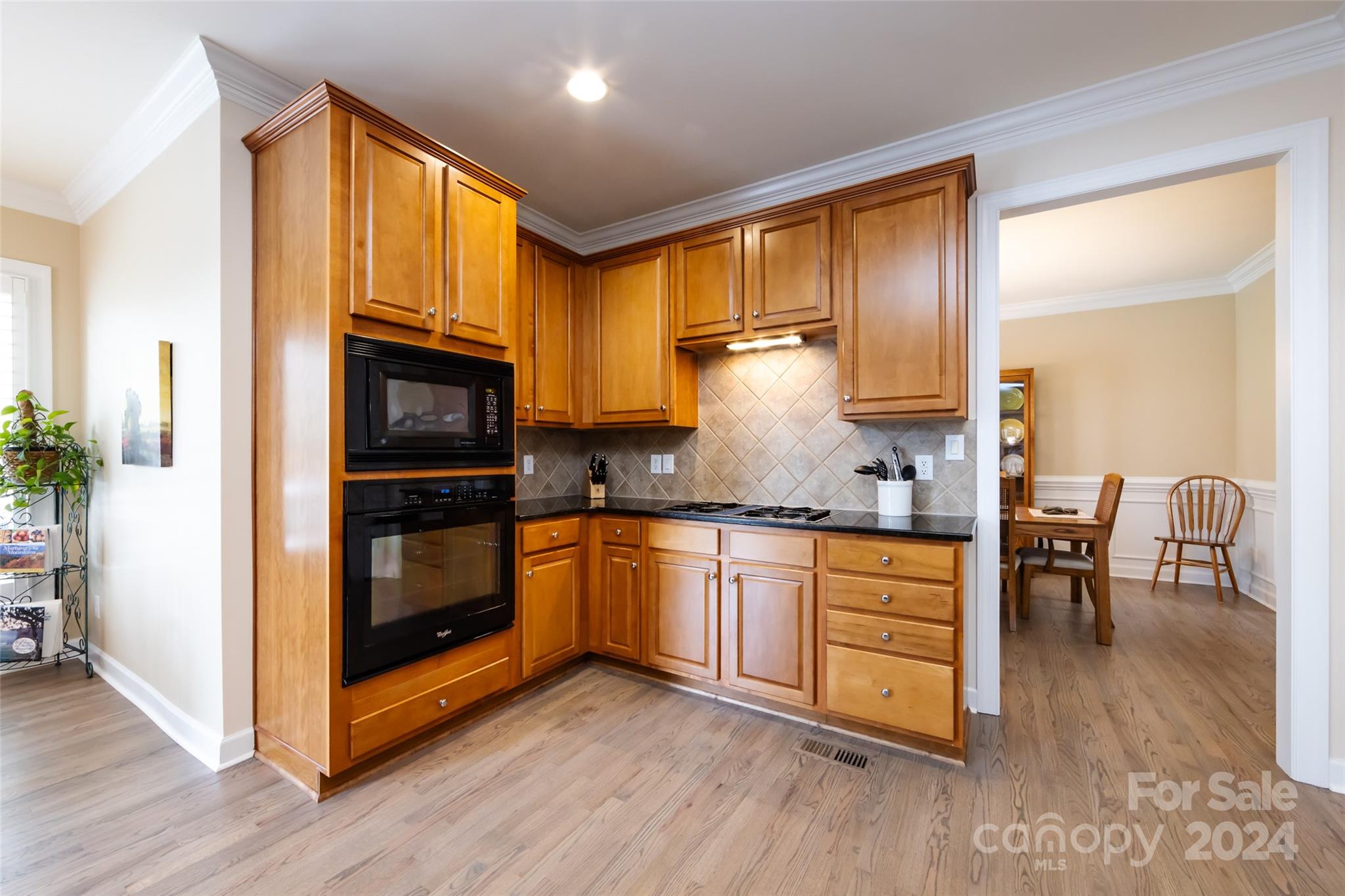 1820 Chestnut Hill Drive Tega Cay, SC 29708 - Photo 14 of 47 a kitchen with granite countertop wooden floors and stainless steel appliances