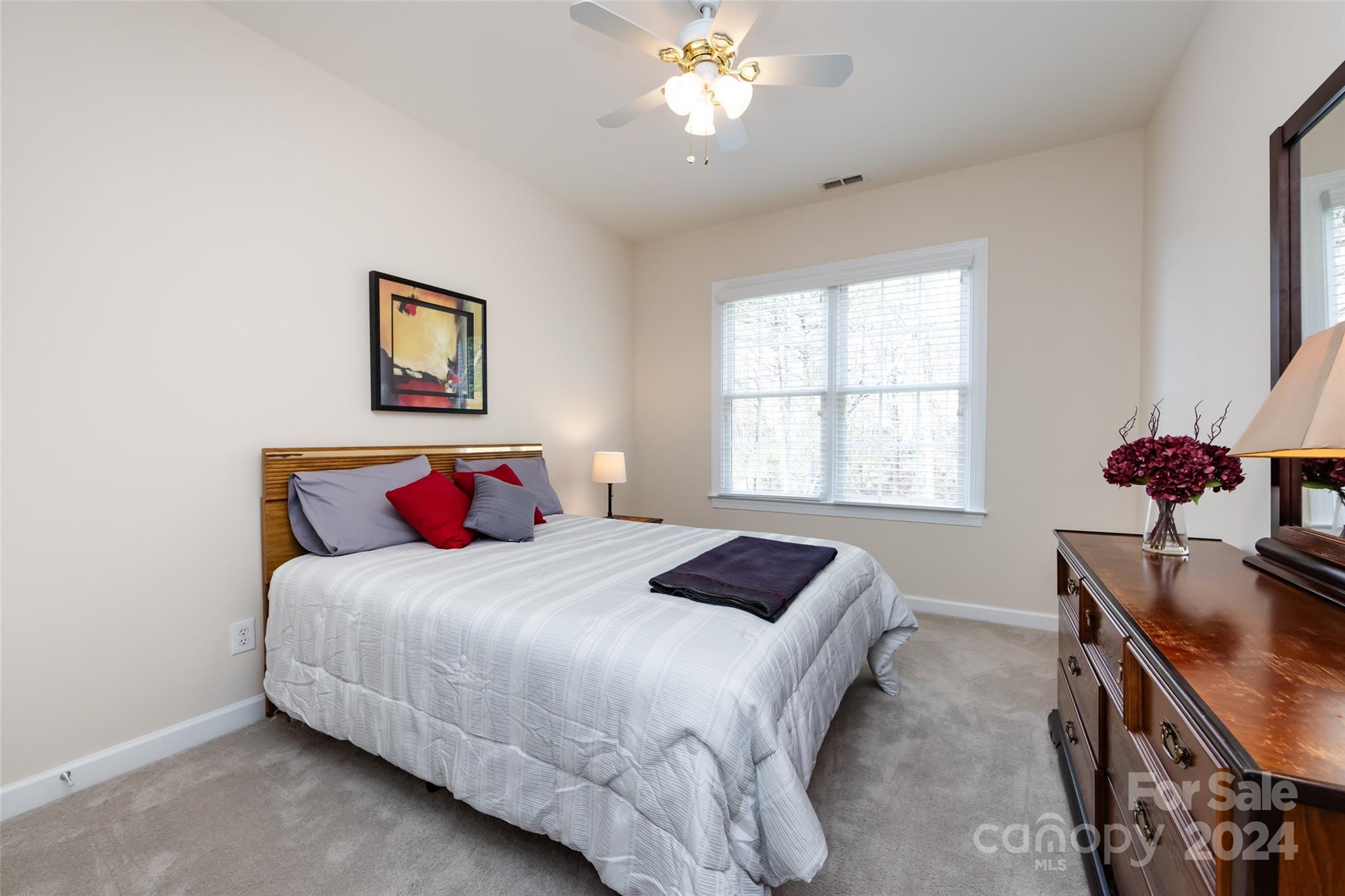 1820 Chestnut Hill Drive Tega Cay, SC 29708 - Photo 35 of 47 a bedroom with a bed and a chandelier