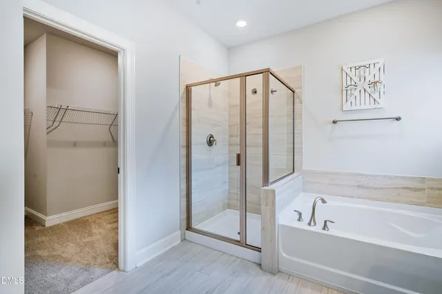 a bathroom with a sink double vanity granite tub and a mirror