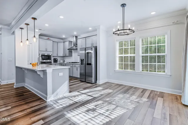 a kitchen with stainless steel appliances a stove and a microwave