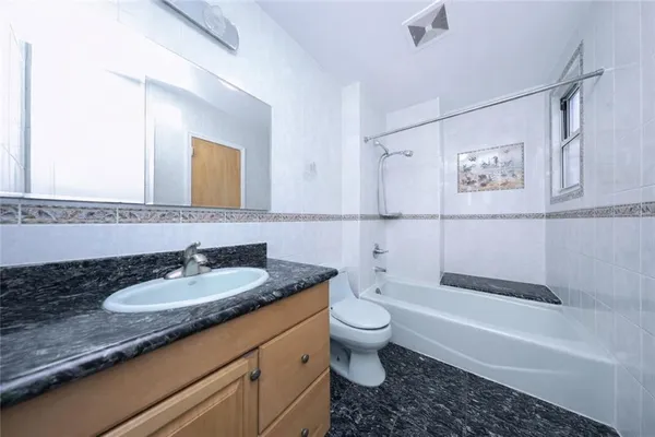 a kitchen with a stove and white cabinets