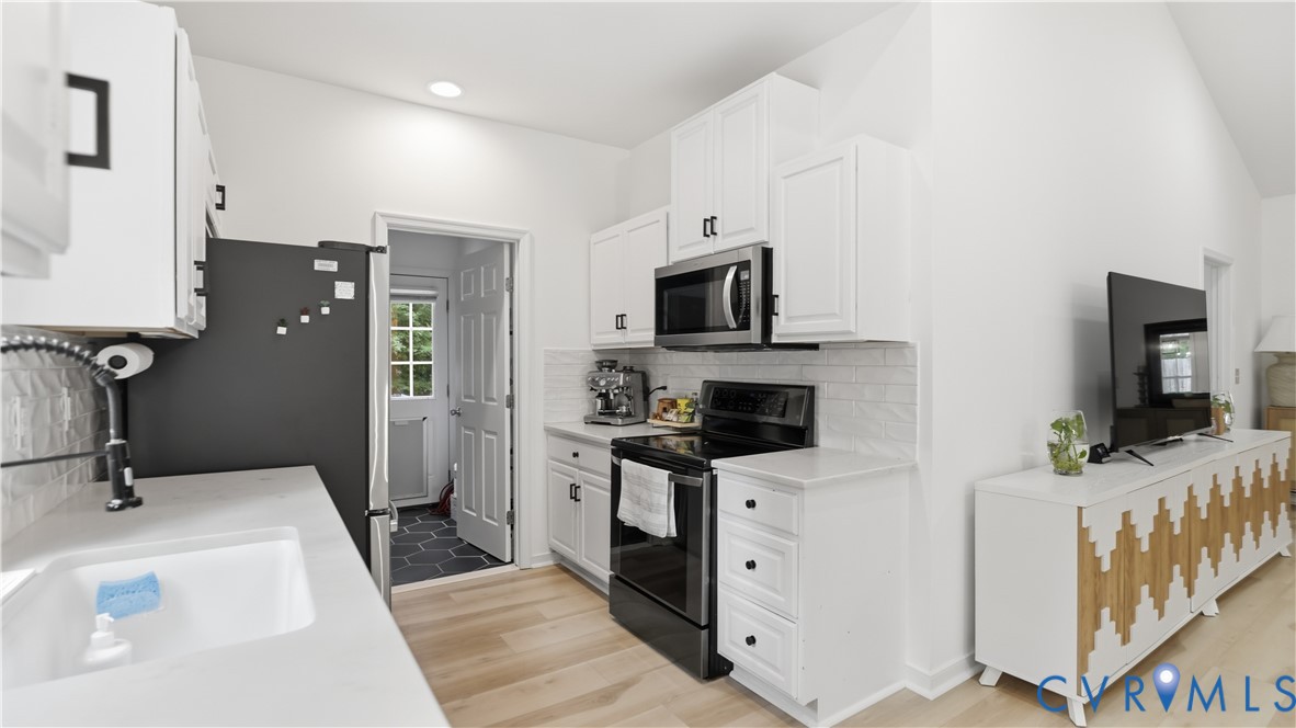 2406 Emanuel Church Road Powhatan, VA 23139 - Photo 15 of 48 Modern kitchen featuring white shaker cabinetry, s