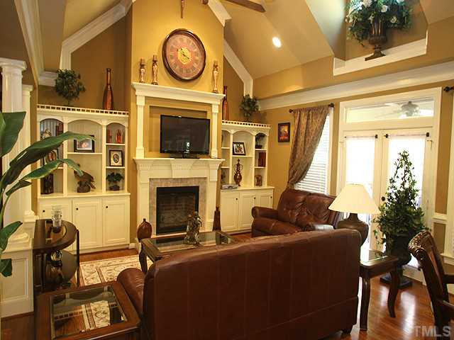 5032 Robinwood Road Durham, NC 27713 - Photo 14 of 25 a living room with furniture a fireplace and a flat screen tv