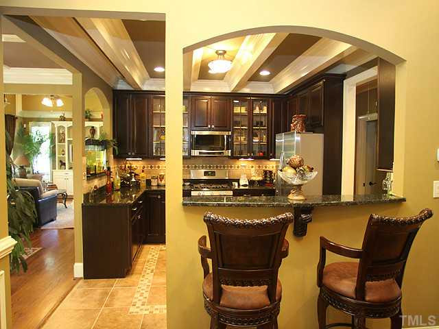 5032 Robinwood Road Durham, NC 27713 - Photo 8 of 25 a kitchen with a refrigerator and a stove