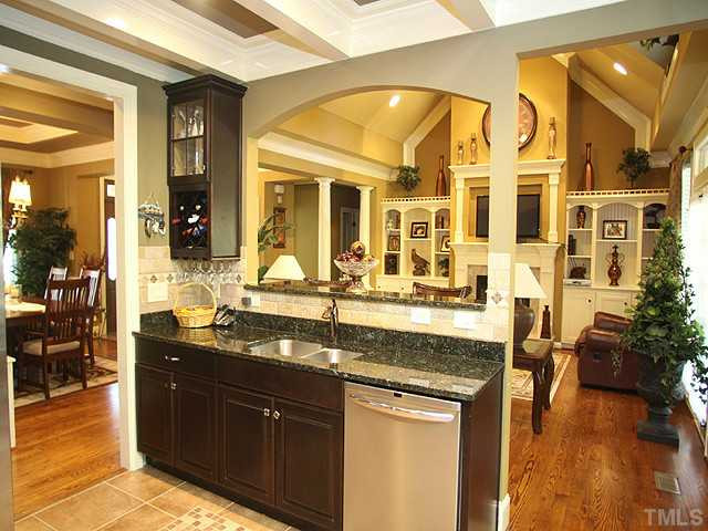 5032 Robinwood Road Durham, NC 27713 - Photo 10 of 25 a kitchen with stainless steel appliances granite countertop a sink and cabinets