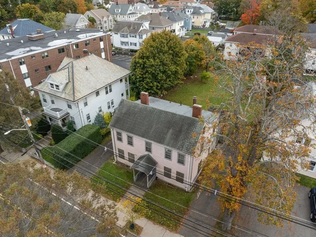 an aerial view of a house with a yard