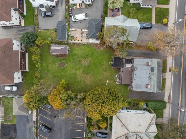 an aerial view of a house with a yard