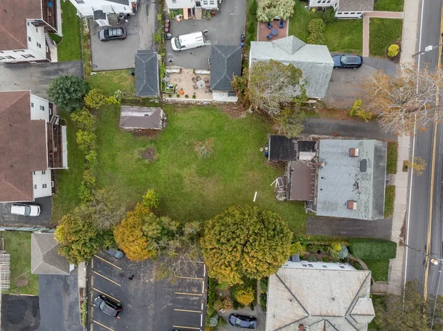 an aerial view of a house with a yard