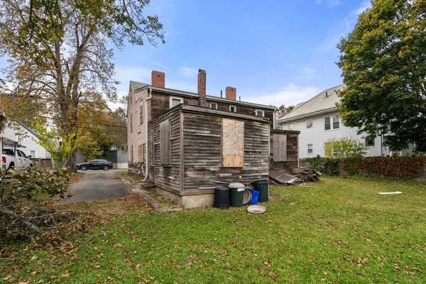 a view of a house with backyard porch and sitting area