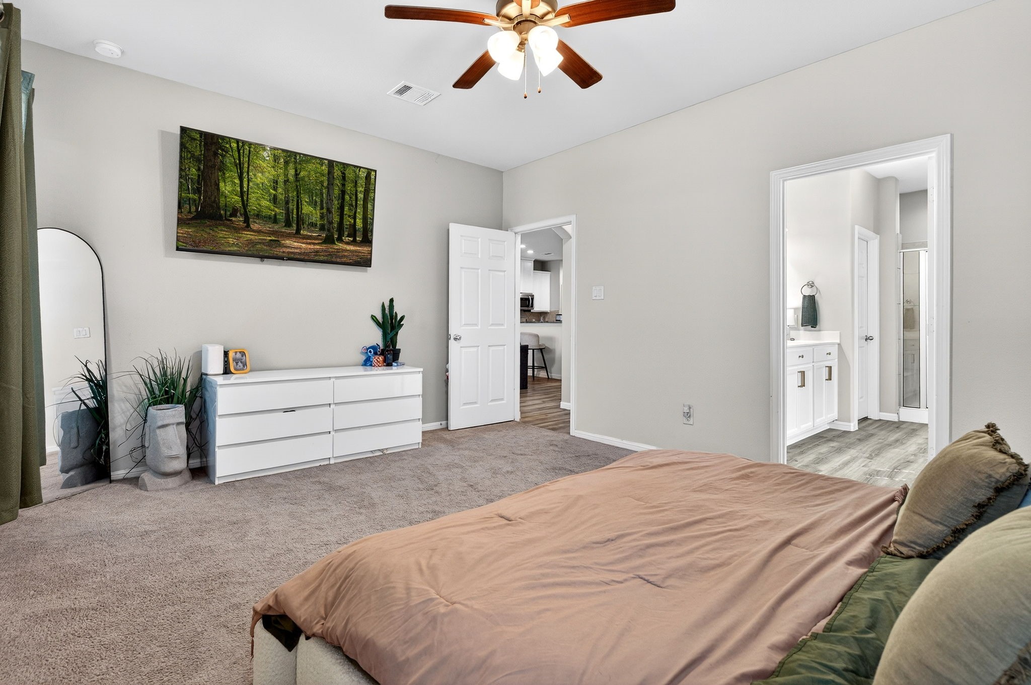 2121 Cedar Way Drive Conroe, TX 77301 - Photo 13 of 27 a bedroom with a large bed and a chandelier fan