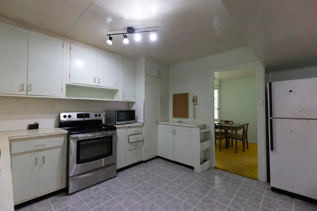 a kitchen with a stove and a refrigerator