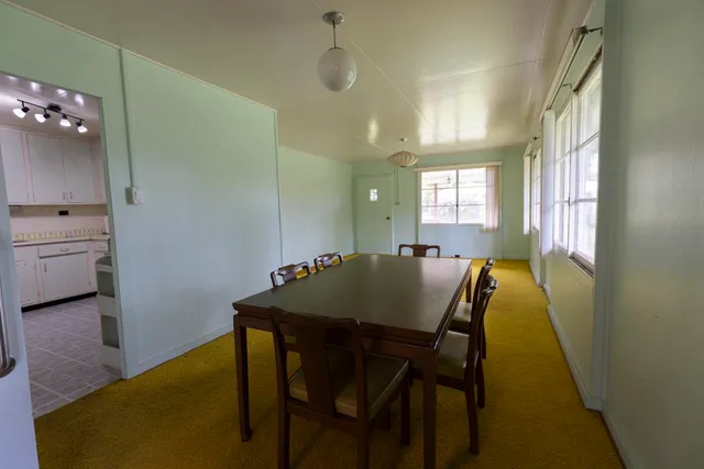a view of a dining room with furniture and window