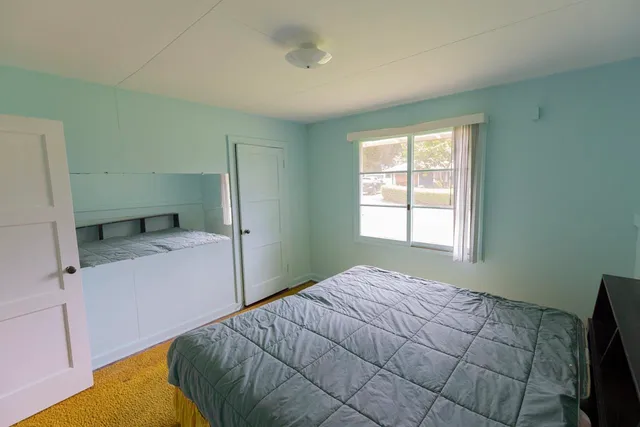 a bedroom with a bed and window