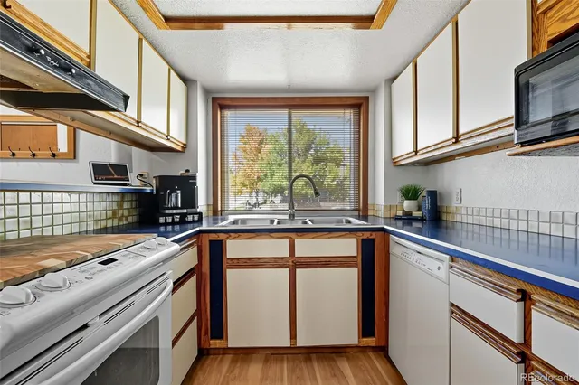 a kitchen with stainless steel appliances granite countertop a sink and a window