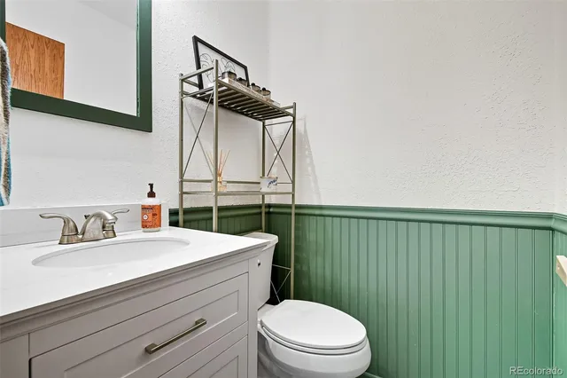 a view of staircase with lots of frames on wall and a window