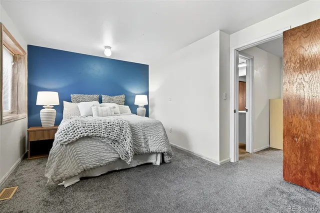 a room with a bed and window