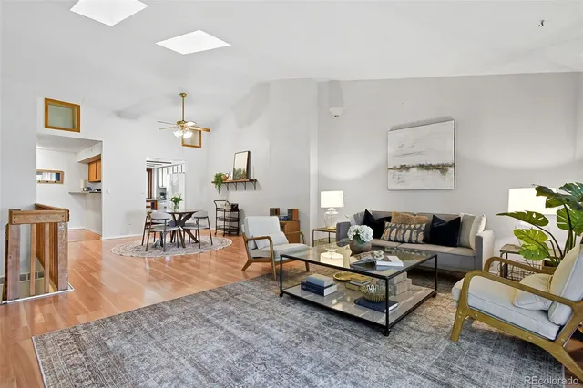 a living room with furniture and wooden floor