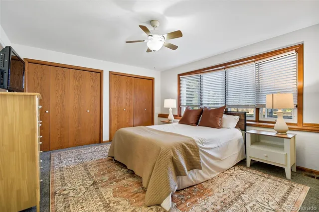 a bedroom with a bed and a couch